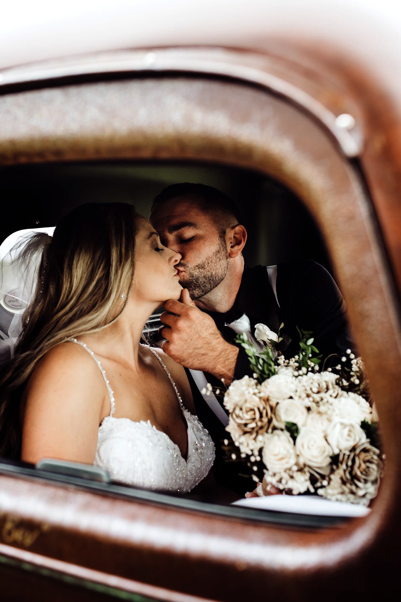 Bride and groom in antique truck