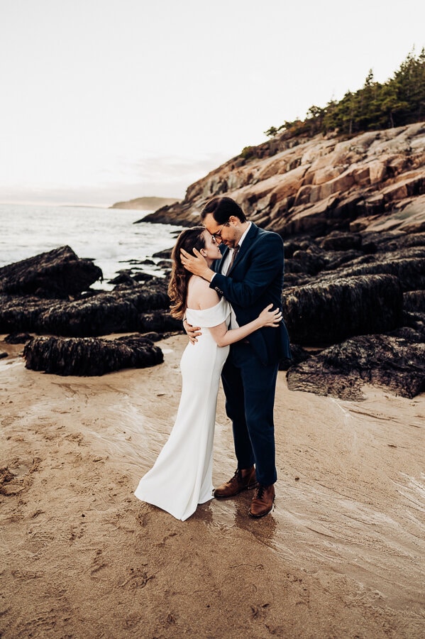 Bride and groom on beach at Acadia