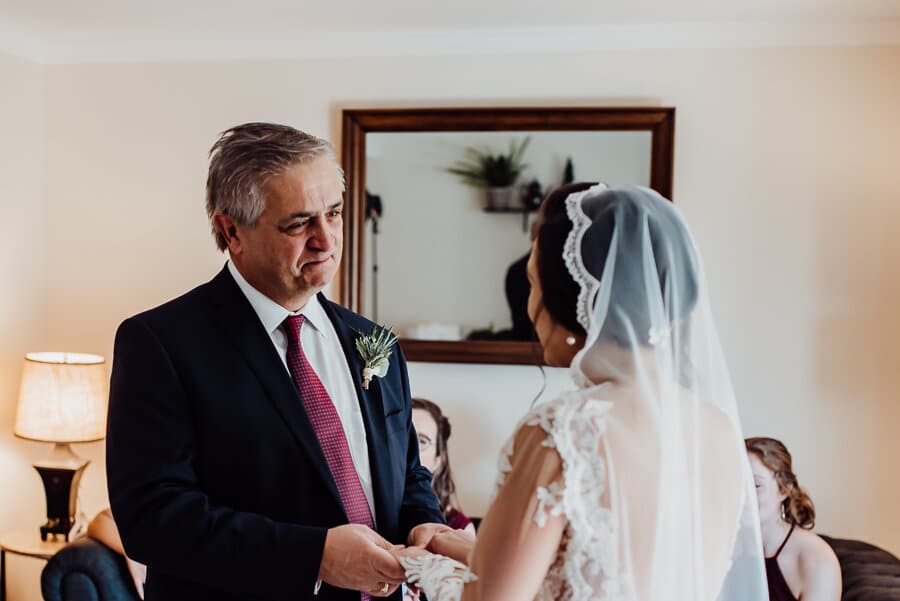 Father looking at bride
