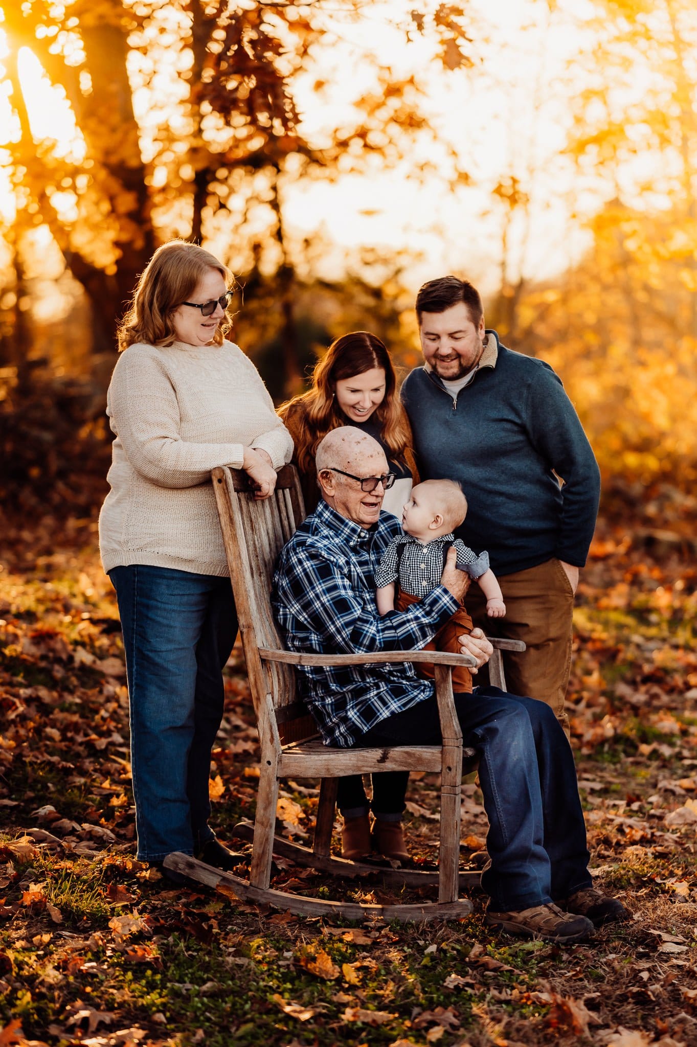 Grandfather and family and baby in rocking chair