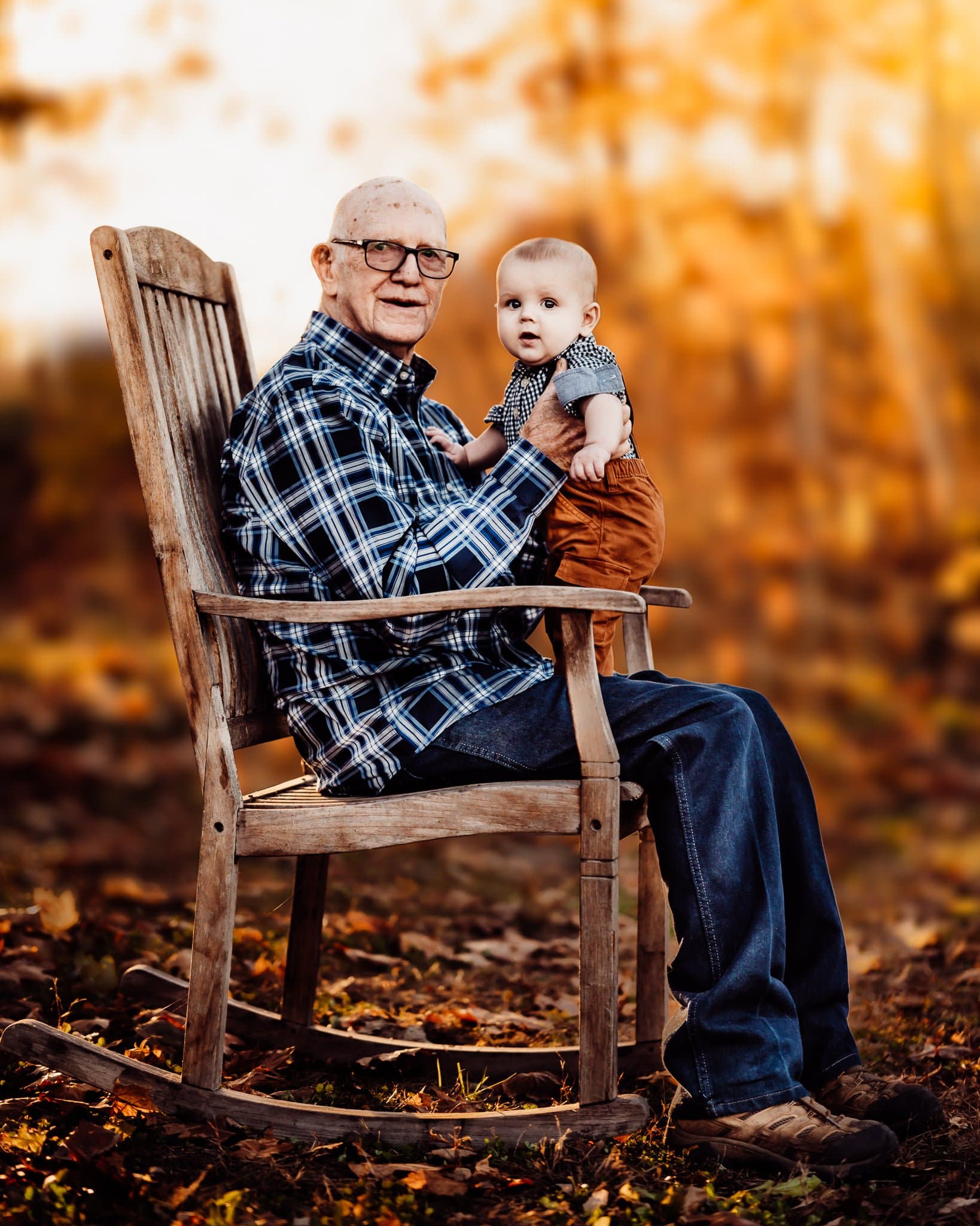 Grandfather sitting on rocking chair with baby