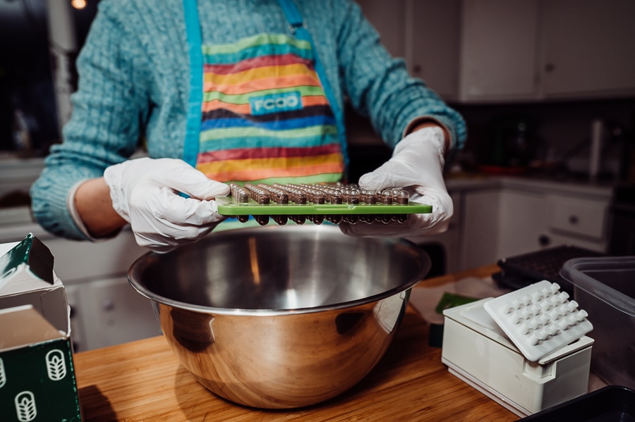 Dropping capsules into bowl