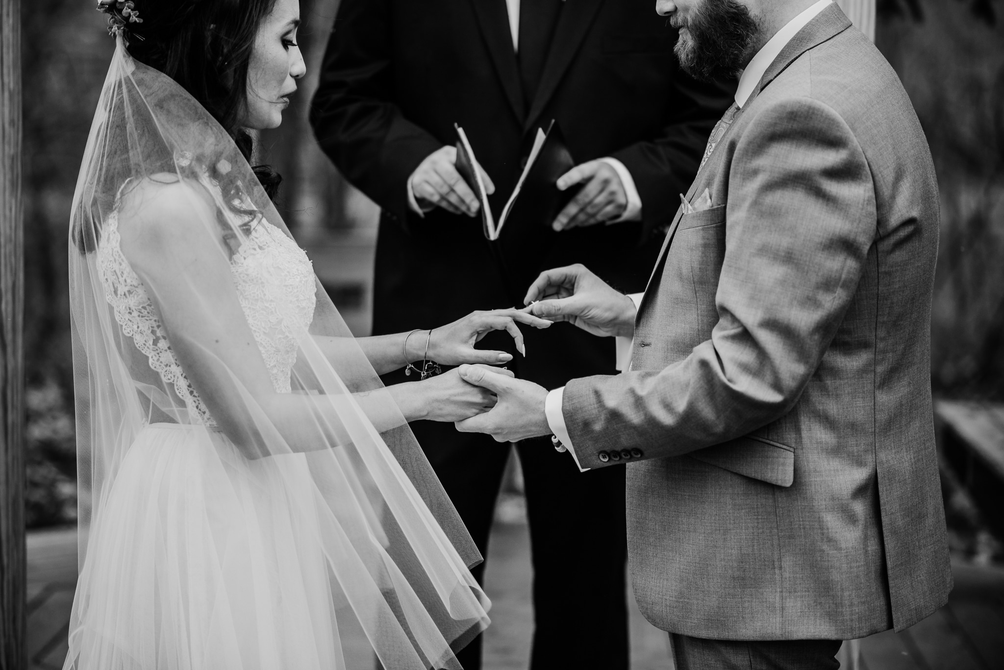 Groom placing ring on brides finger in dover wedding