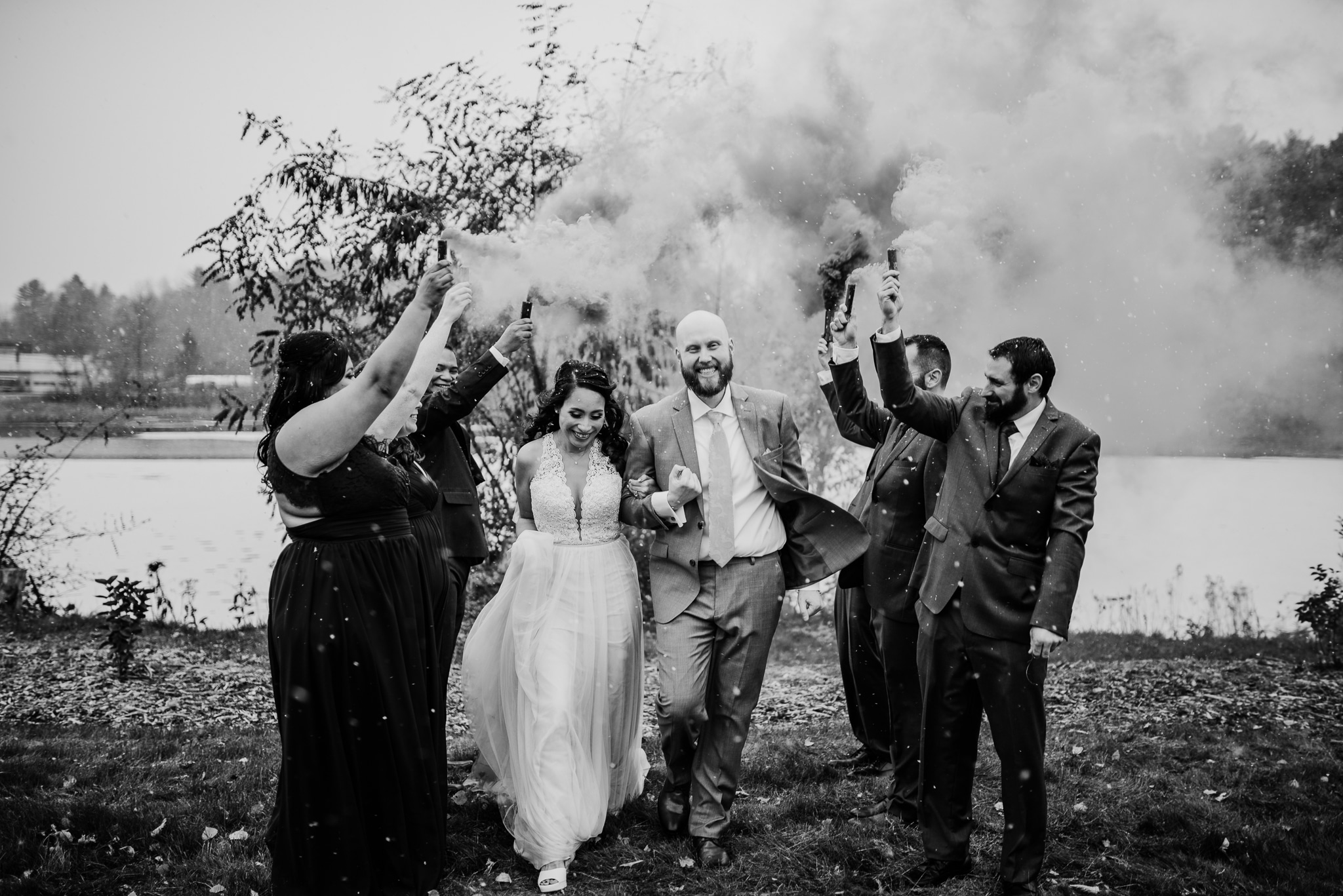 Bride and groom walking between wedding smoke bomb