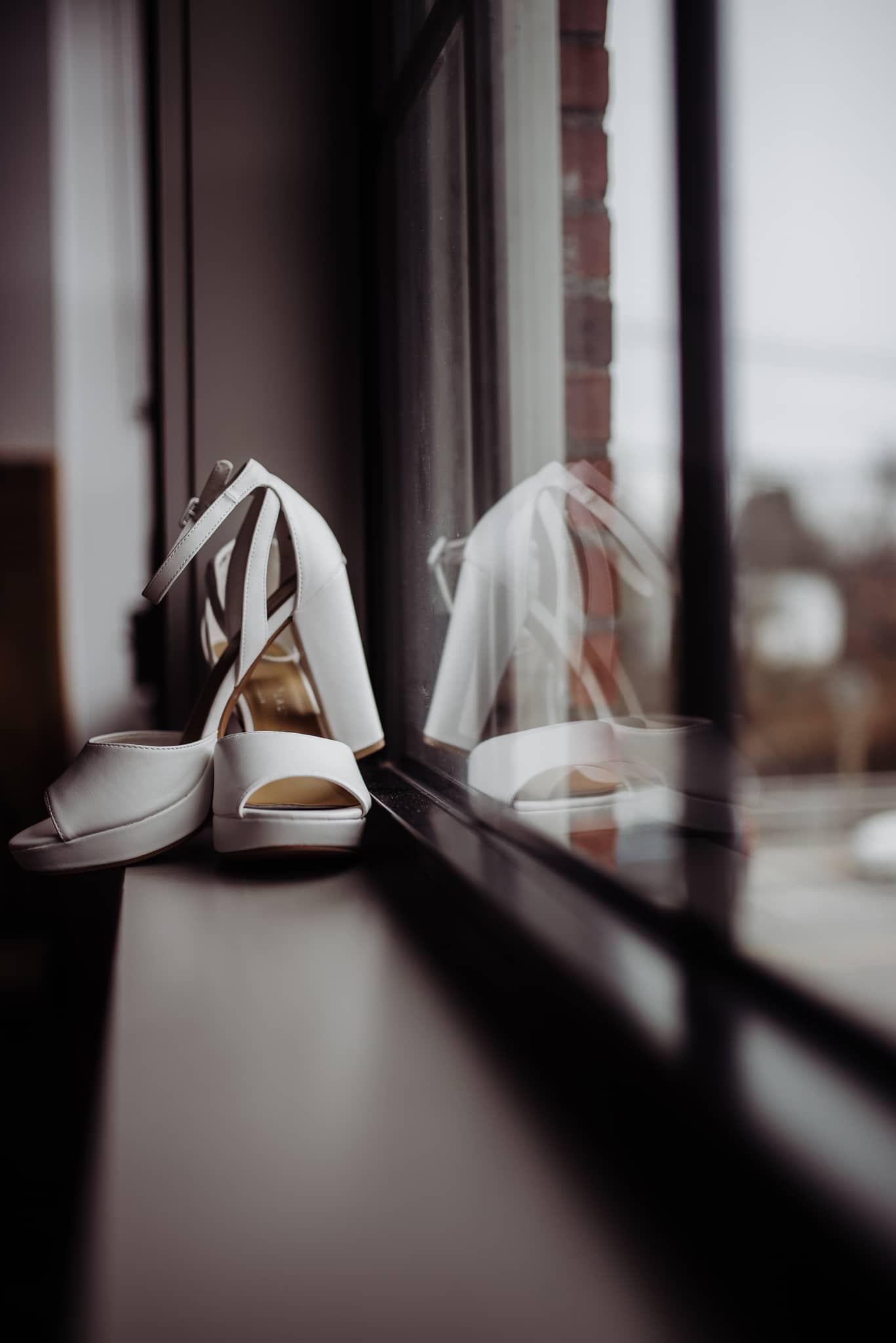 Wedding shoes sitting in window sill