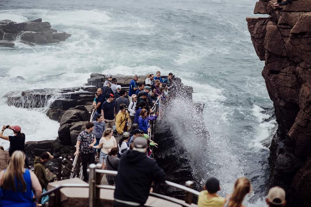 People looking at Thunder hole in acadia national park