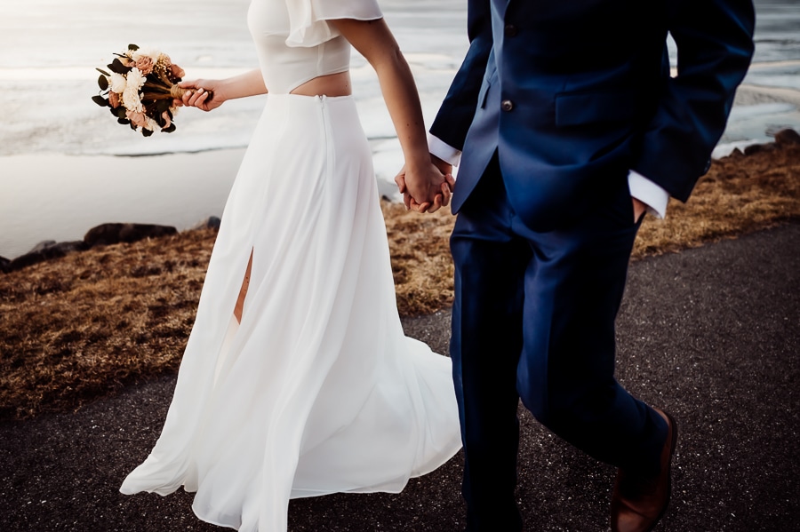 Headless photo of bride and groom walking