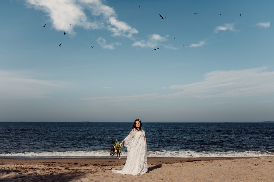 Bride holding flowers on the beach