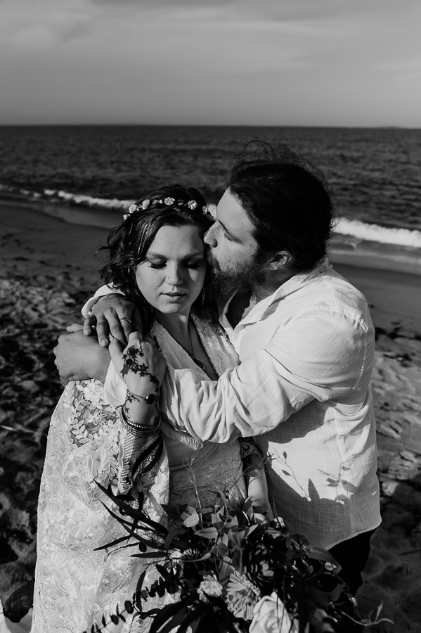 Groom kissing bride on cheek at old orchard beach