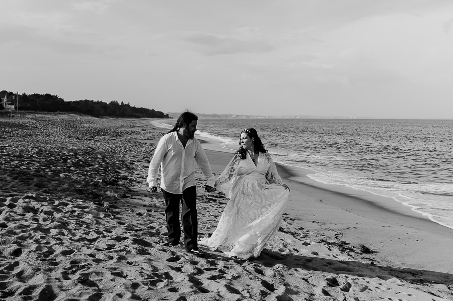 black and white bride and groom walking on old orchard beach