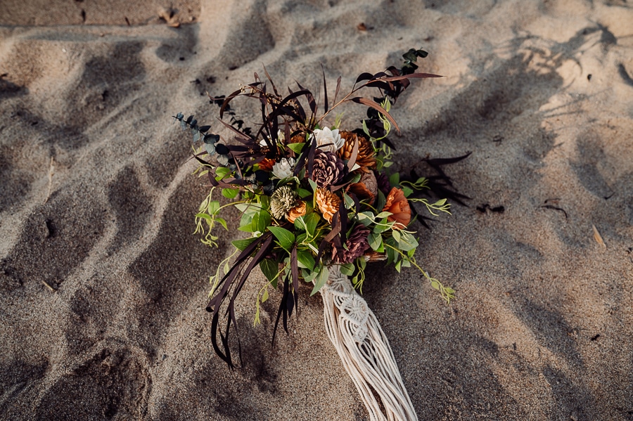 Bridal bouquet made of wooden flowers on beach