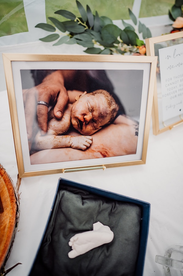 Framed image of baby and foot casting in a box