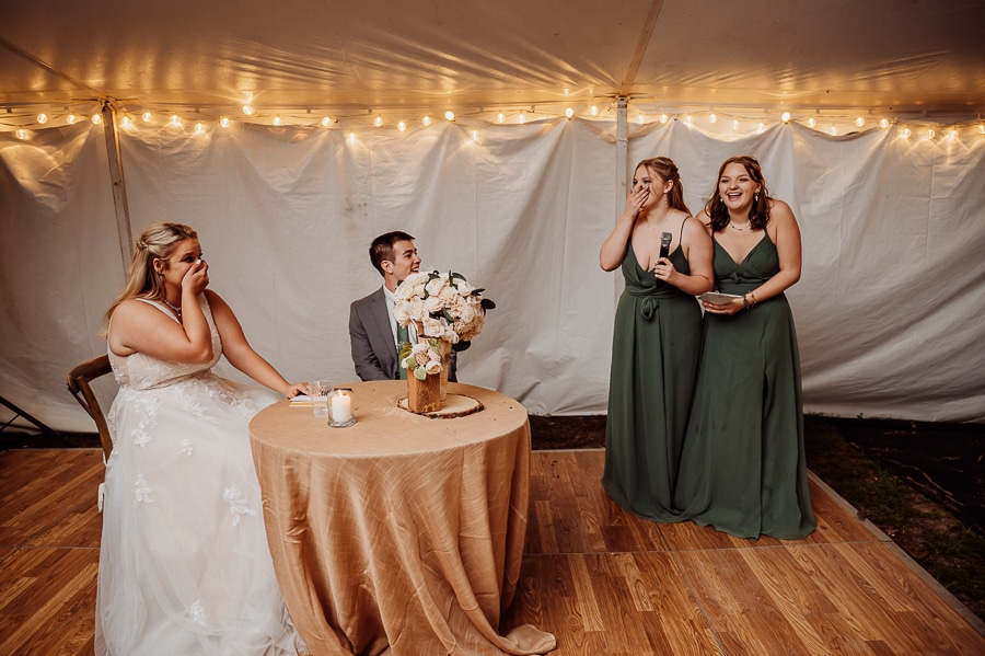 Emotional bridesmaids giving speech while crying together