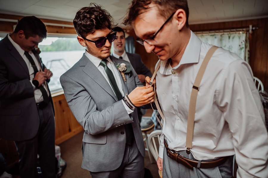 Groomsmen getting dressed together before wedding