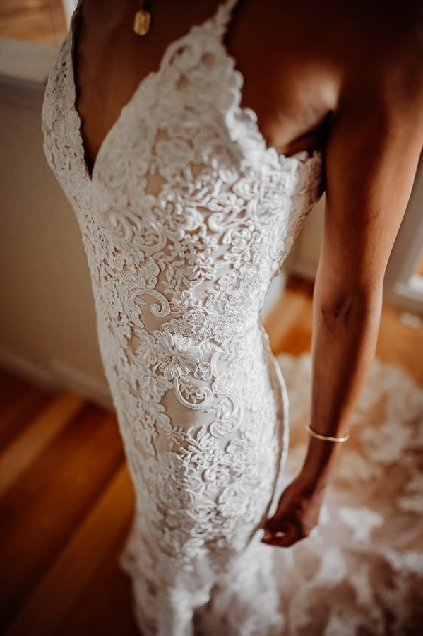Bride wearing wedding dress up close with lace detail
