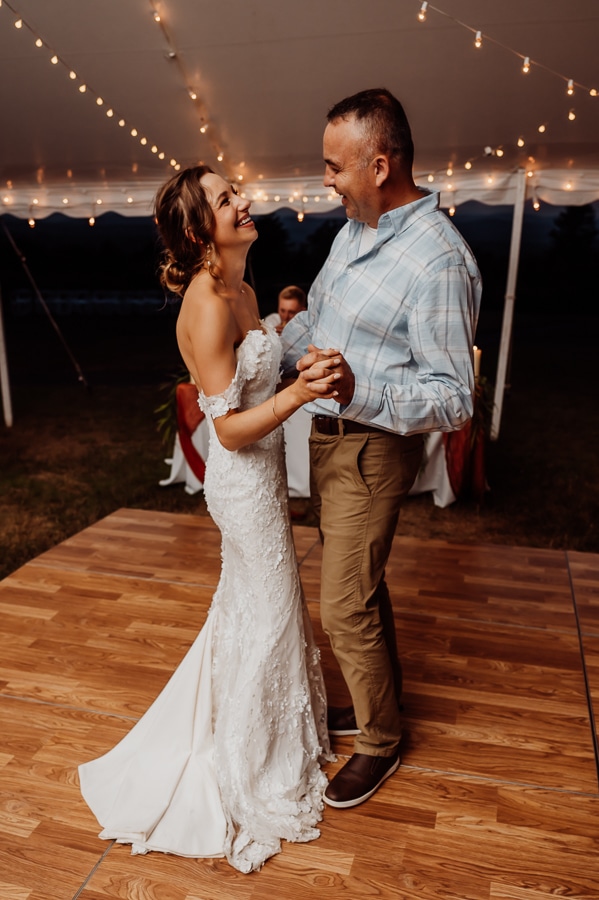 Father and daughter dancing at wedding under tent