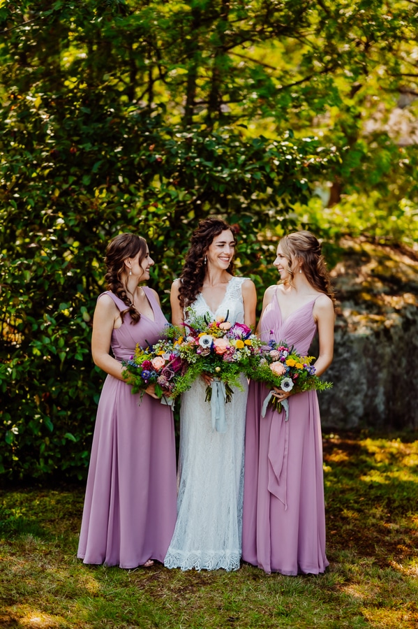 Bride and bridesmaids laughing and looking at each other