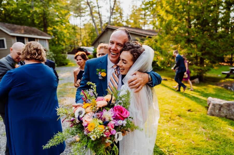 bride hugging father after wedding at big moose inn