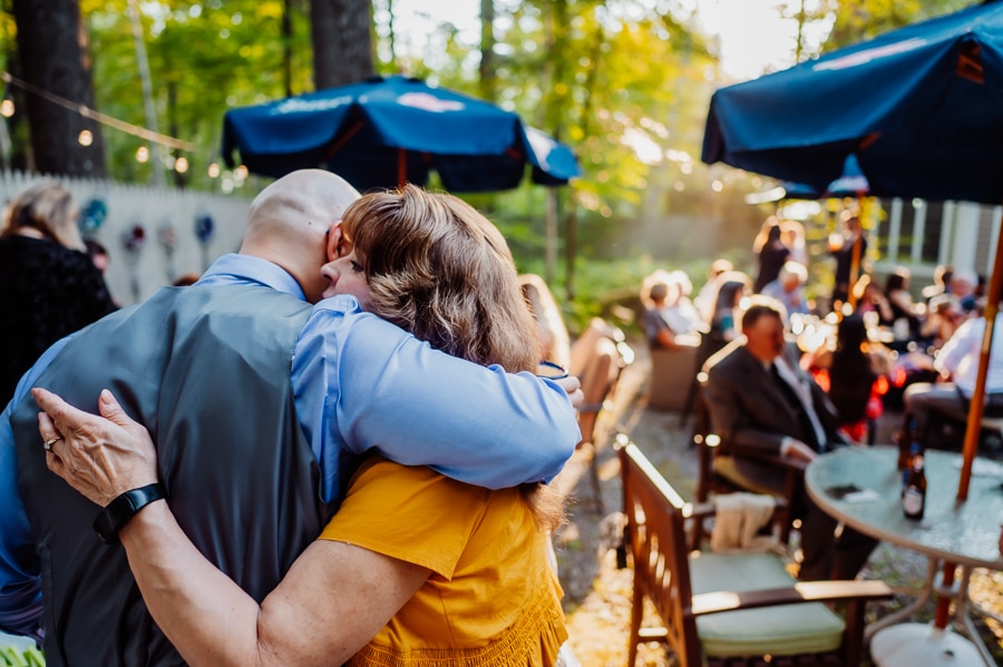 Groom and mother hugging at big moose inn wedding reception