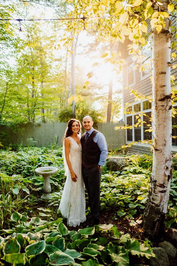 Bride and groom posing in garden area at big moose inn