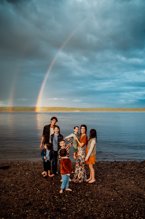 family of 8 in front of stockton springs and double rainbow