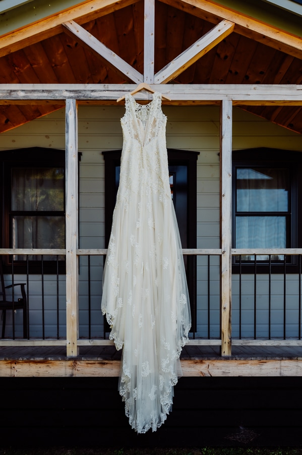 Grayce Formal bridal dress hanging over porch