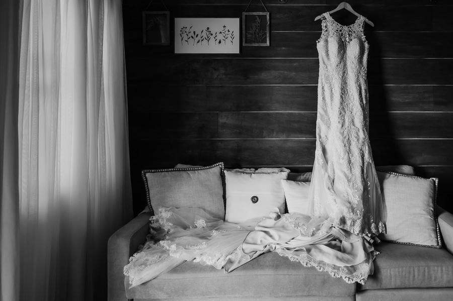 Wedding dress hanging in cabin at the waters edge estate venue