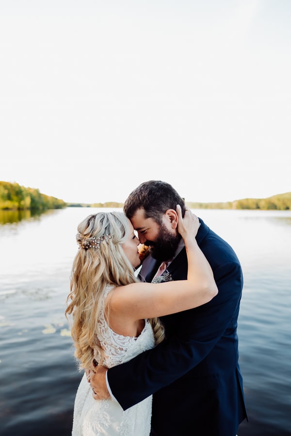 bride and groom on dock at the waters edge estate in skowhegan