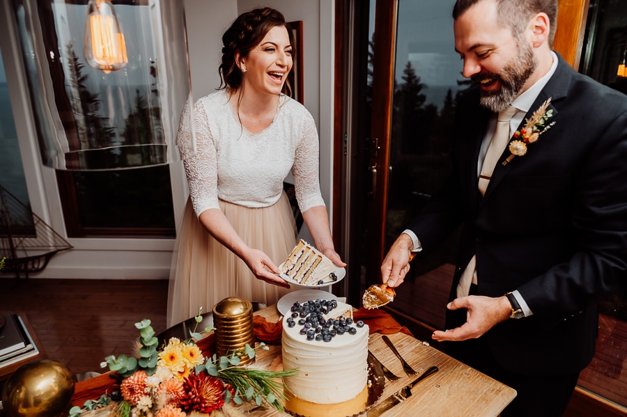 Bride and groom cutting cake inside machiasport airbnb