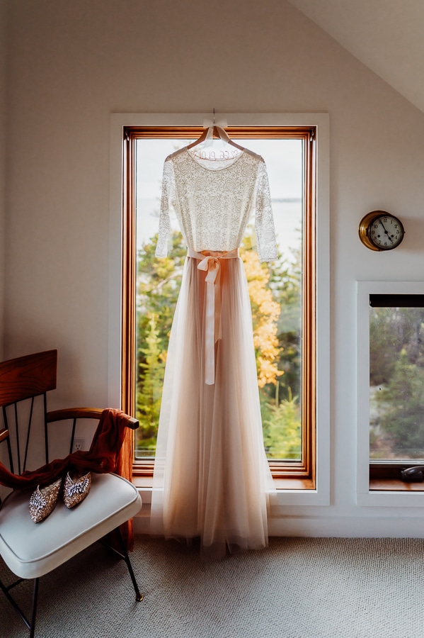 Wedding dress hanging in window in machiasport Airbnb