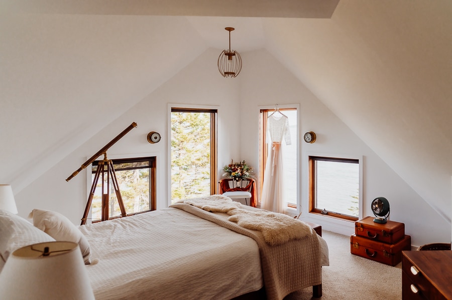 machiasport airbnb bedroom with wedding dress hanging in window