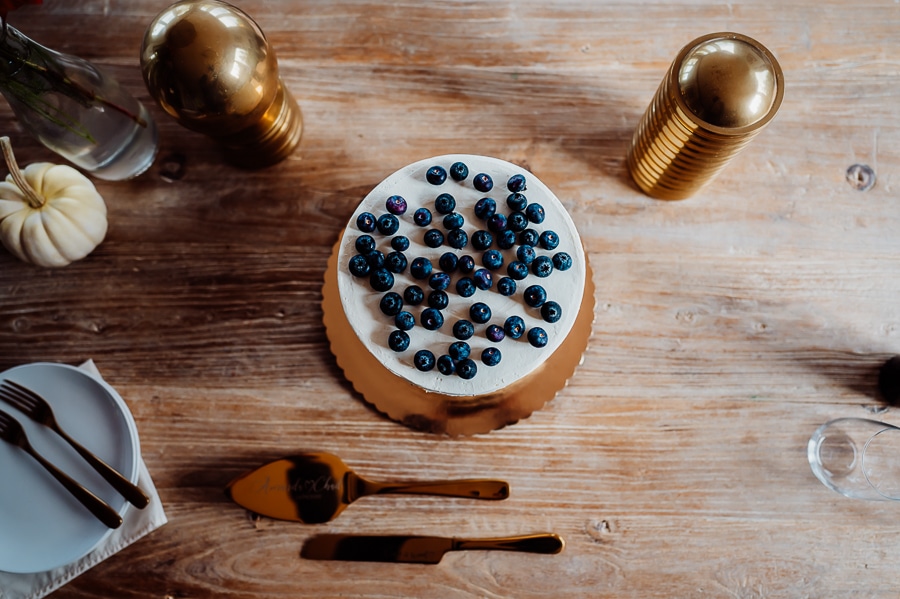 Blueberries on wedding cake sitting on table