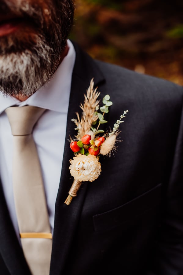 boutonniere with harvest flowers on groom