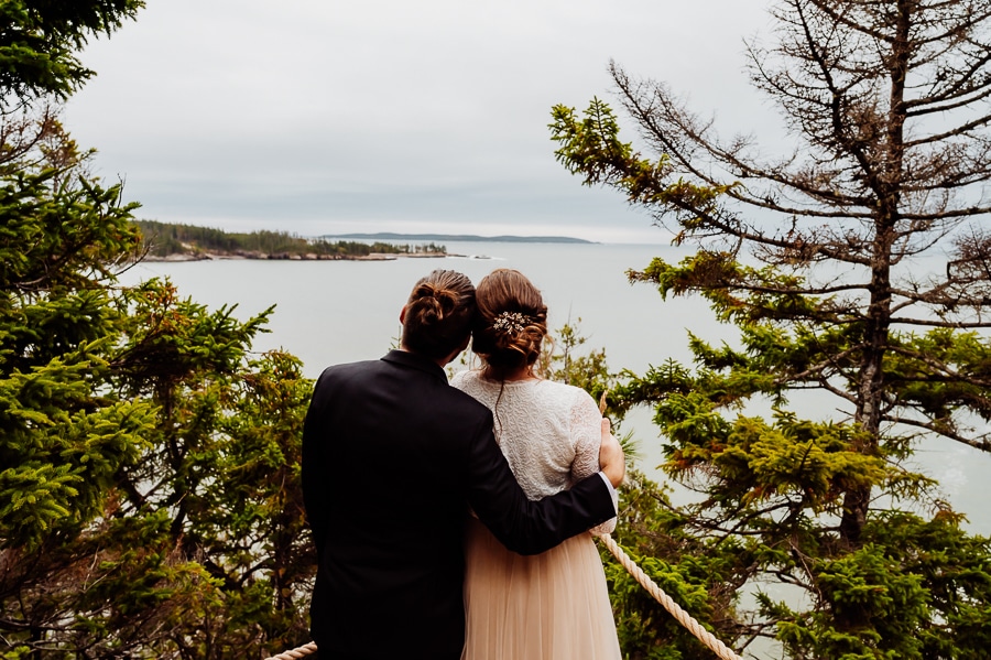 bride and groom from behind looking at ocean view