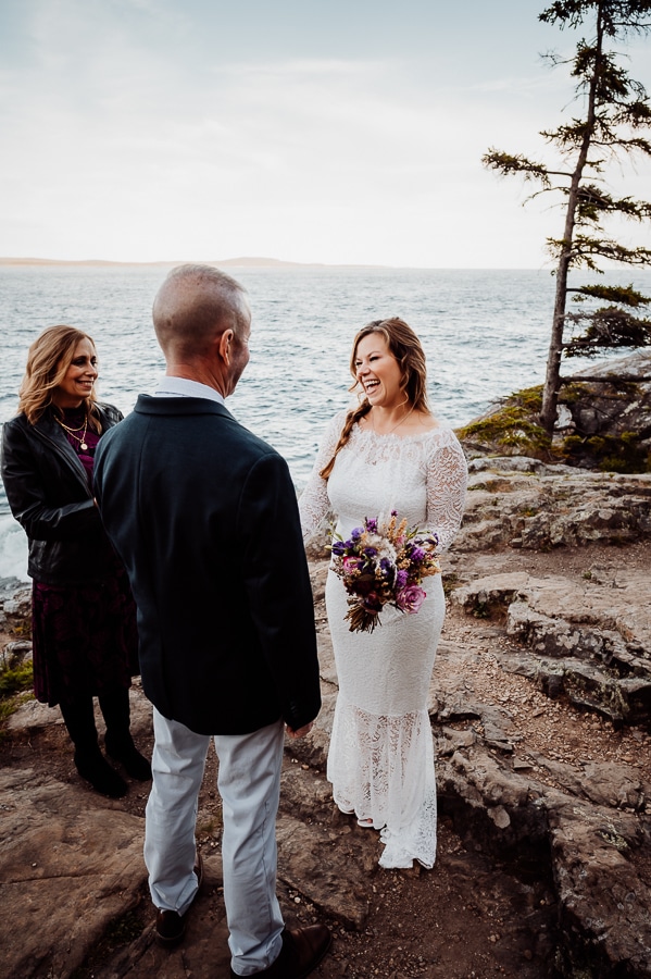Bride laughing with groom during elopement ceremony at Scoodic overlook