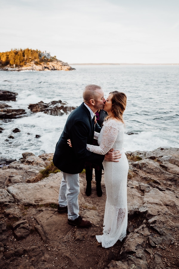 Bride and groom kissing at elopement ceremony at scoodic overlook in Acadia national park