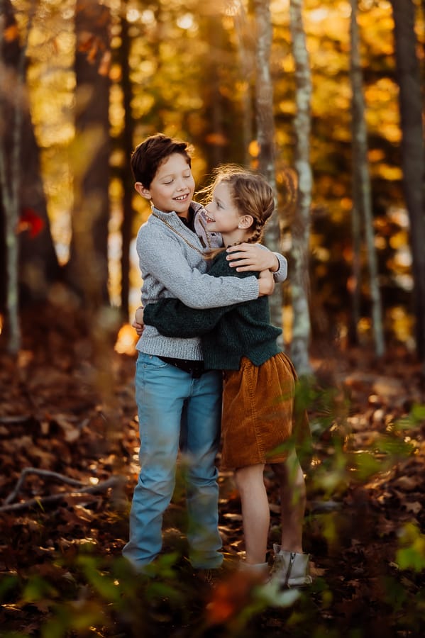Boy and girl siblings hugging each others